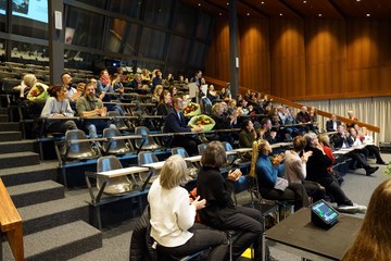 Applaus in der Aula der Schule für Gestaltung Bern. Vergrösserte Ansicht